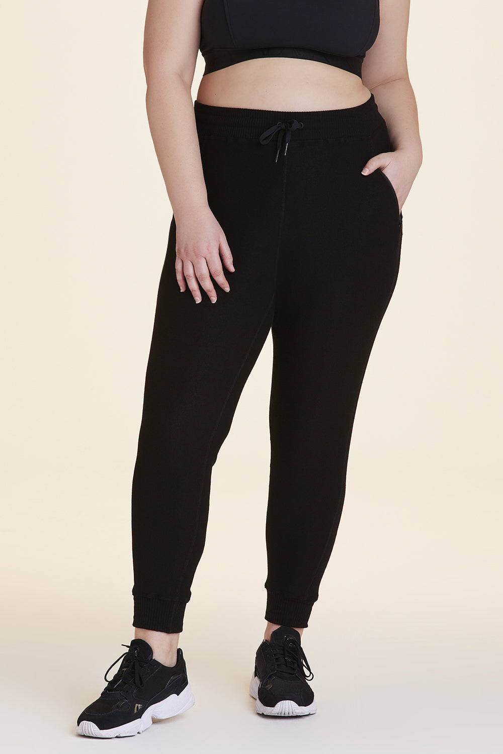 Front view of Alala Women's Luxury Athleisure black sweatpant in plus size