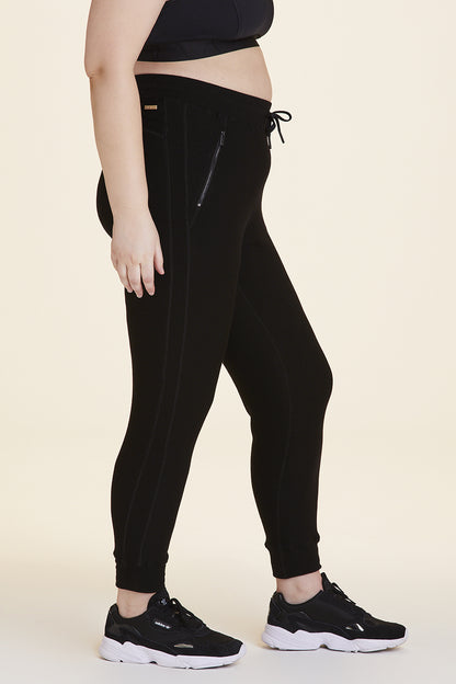 Side  view of Alala Women's Luxury Athleisure black sweatpant in plus size