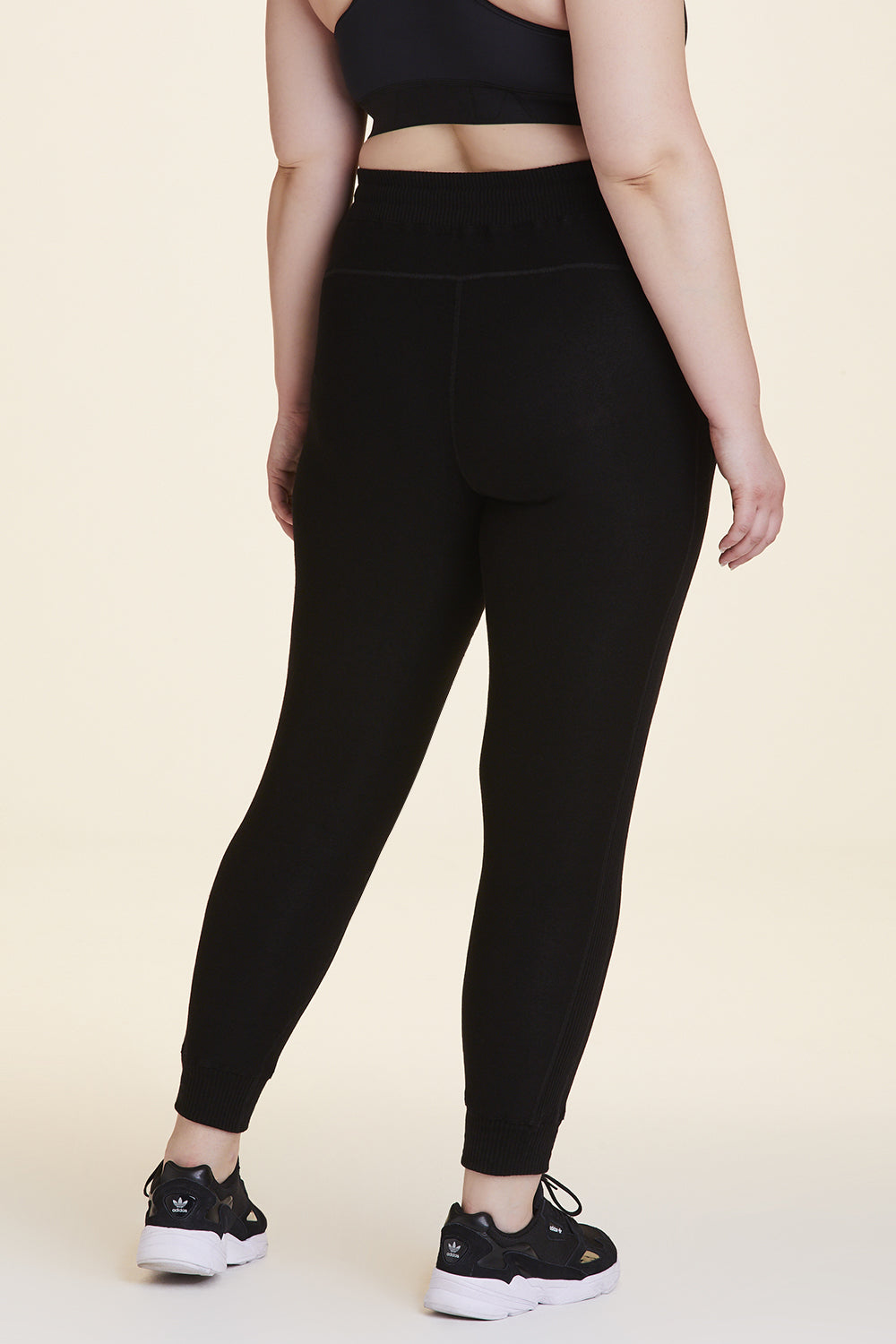 Back view of Alala Women's Luxury Athleisure black sweatpant in plus size
