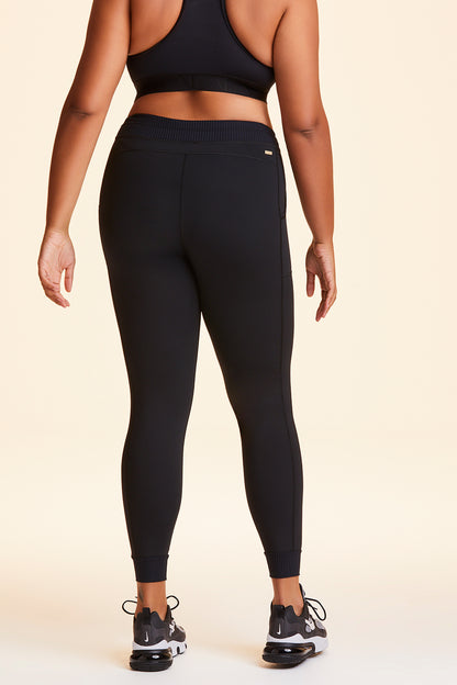 Back view of Alala Women's Luxury Athleisure black jogger-style tight in plus size