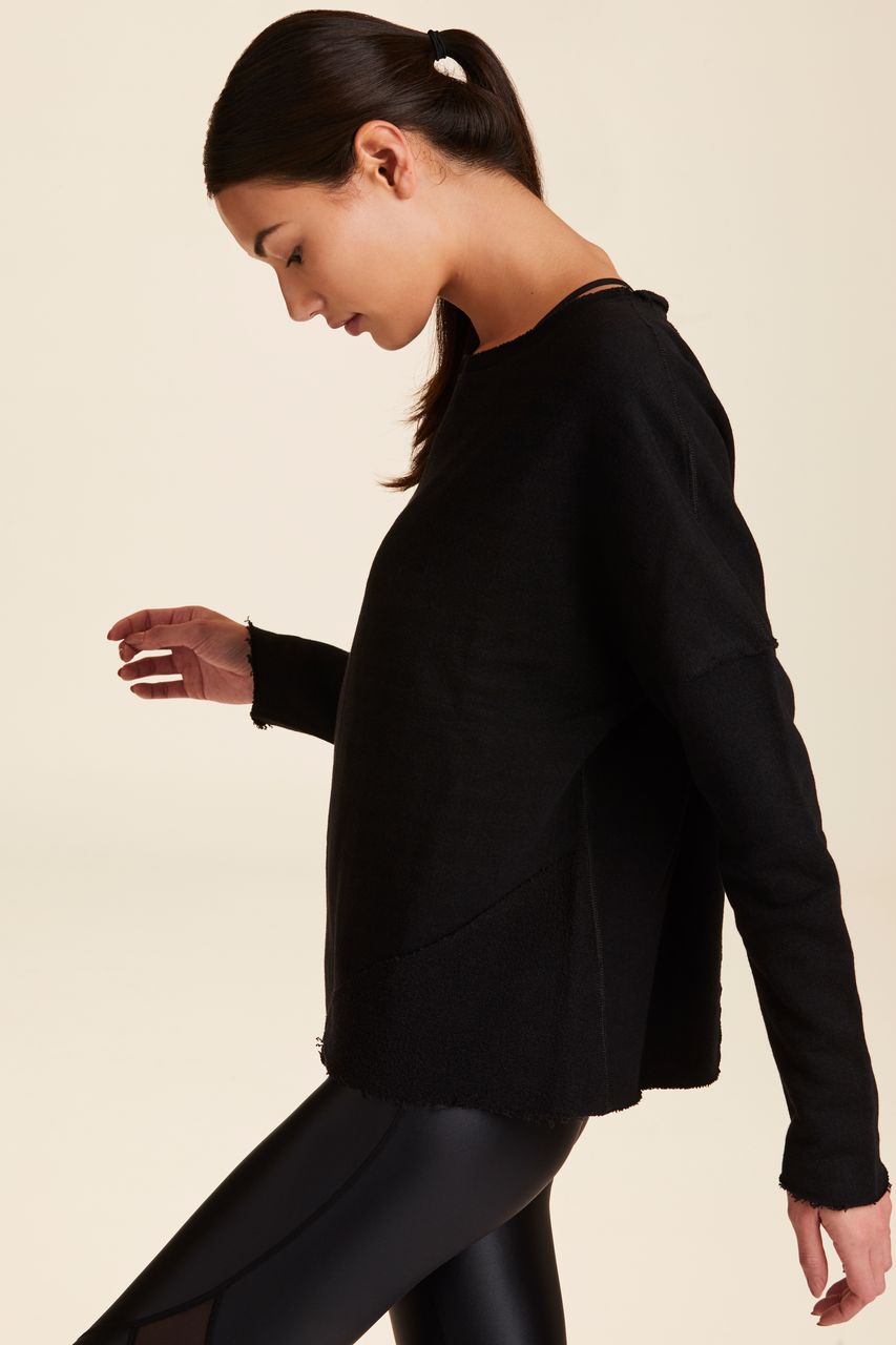 Side view of Alala Women's Luxury Athleisure black sweatshirt with distressed details on seams