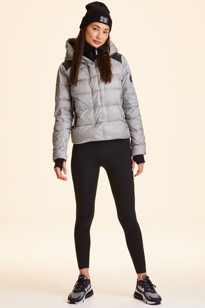 Front view of Alala Women's Luxury Athleisure silver puffer jacket