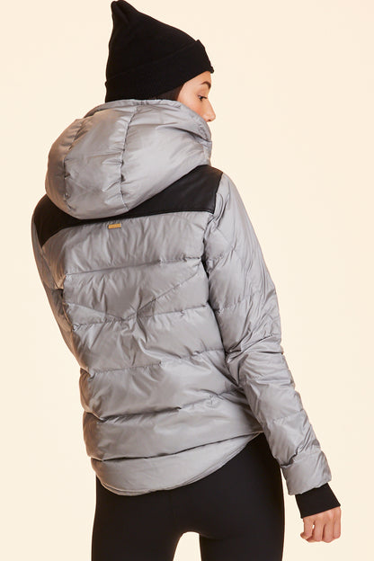 Back view of Alala Women's Luxury Athleisure silver puffer jacket