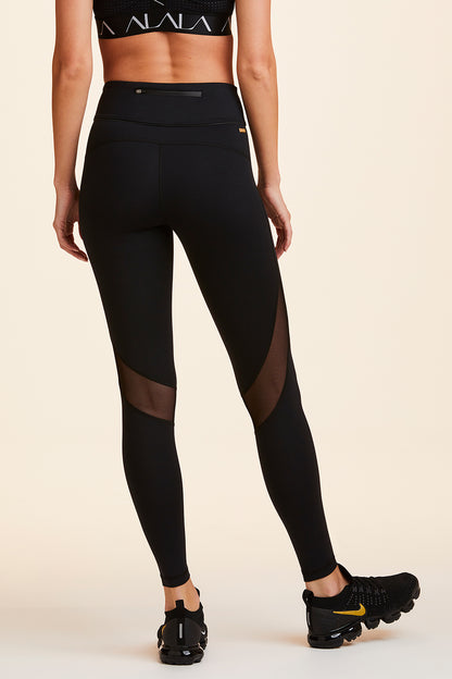 Back view of Alala Women's Luxury Athleisure black tight with mesh paneling on back of knees