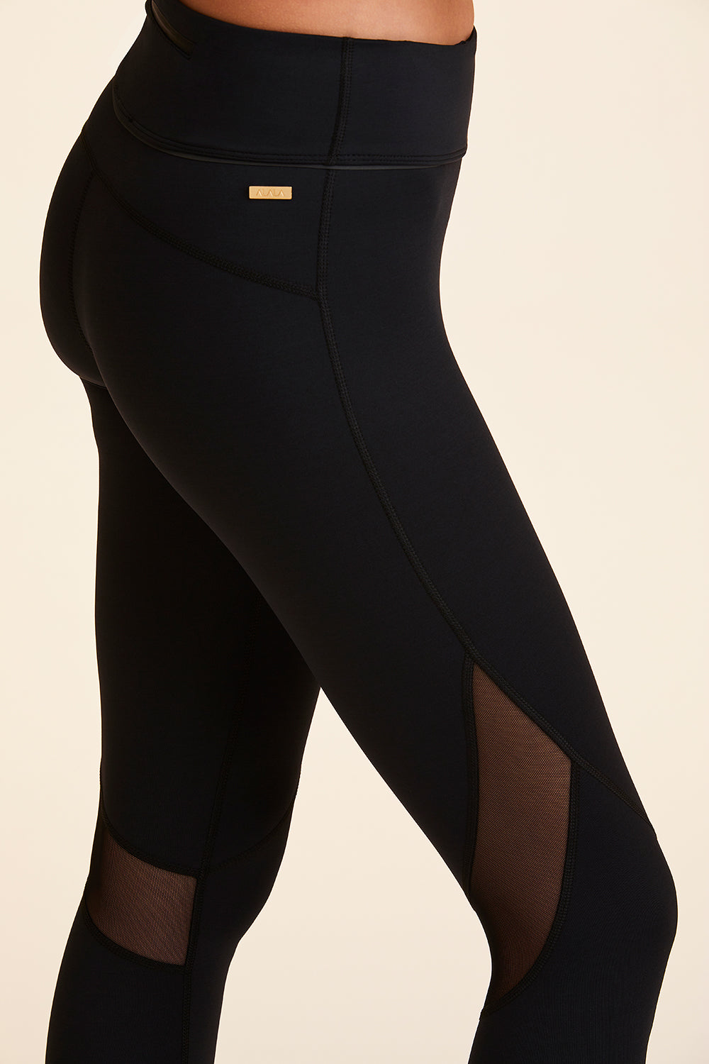 Close up of Alala Women's Luxury Athleisure black tight with mesh paneling on back of knees