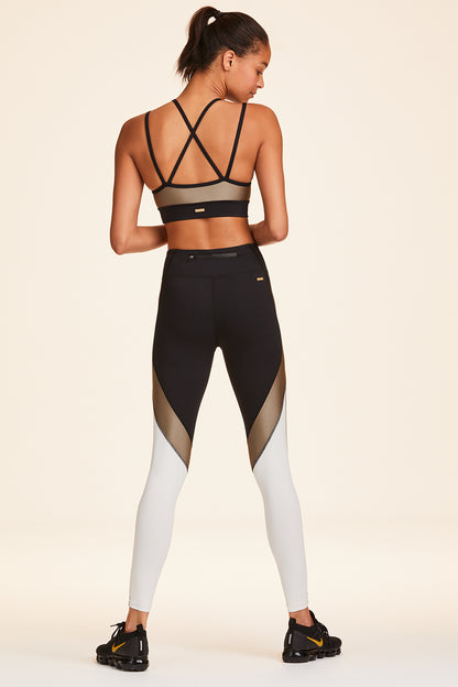 Full back view of Alala Women's Luxury Athleisure blocked sports bra with criss-crossed straps in gold, white, & black