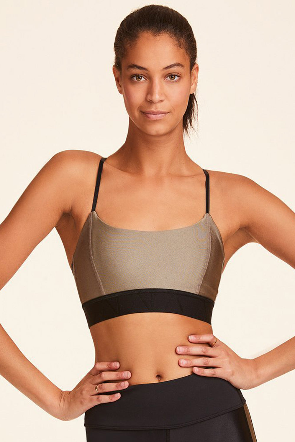 Front view of Alala Luxury Women's Athleisure gold sports bra with thin adjustable straps + elastic band