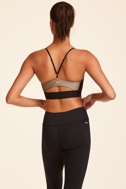Back view of Alala Luxury Women's Athleisure gold sports bra with thin adjustable straps + elastic band