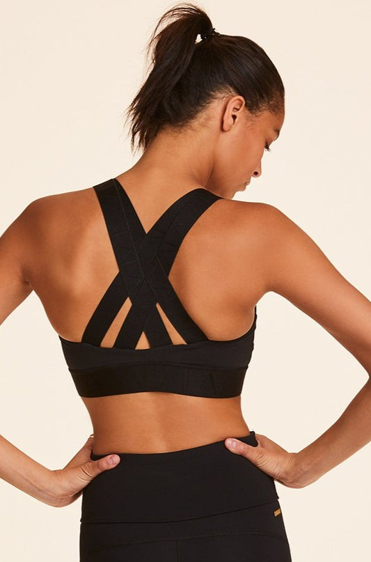 Back view of Alala Women's Luxury Athleisure black sports bra with cross back straps