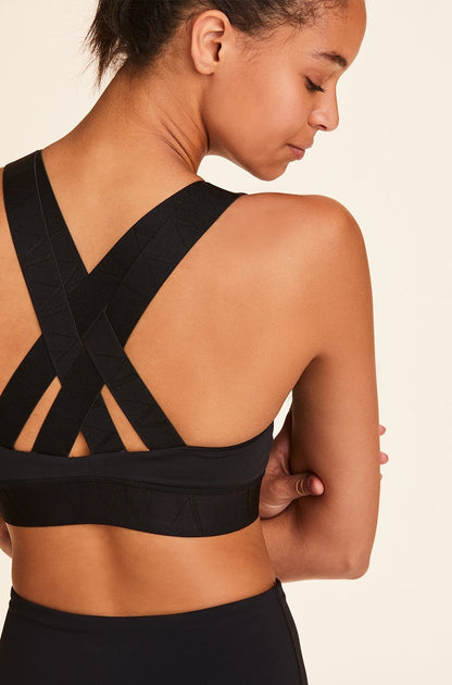 Back view of Alala Women's Luxury Athleisure black sports bra with cross back straps