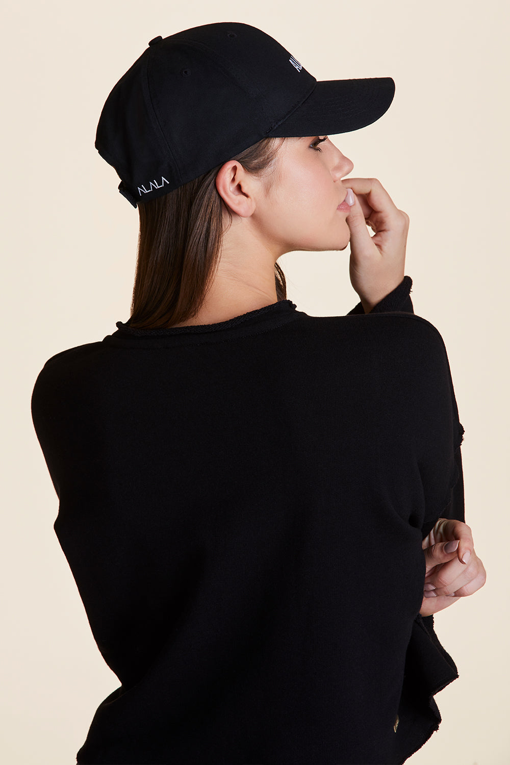 Side view of Alala Women's Luxury Athleisure all day baseball cap in black