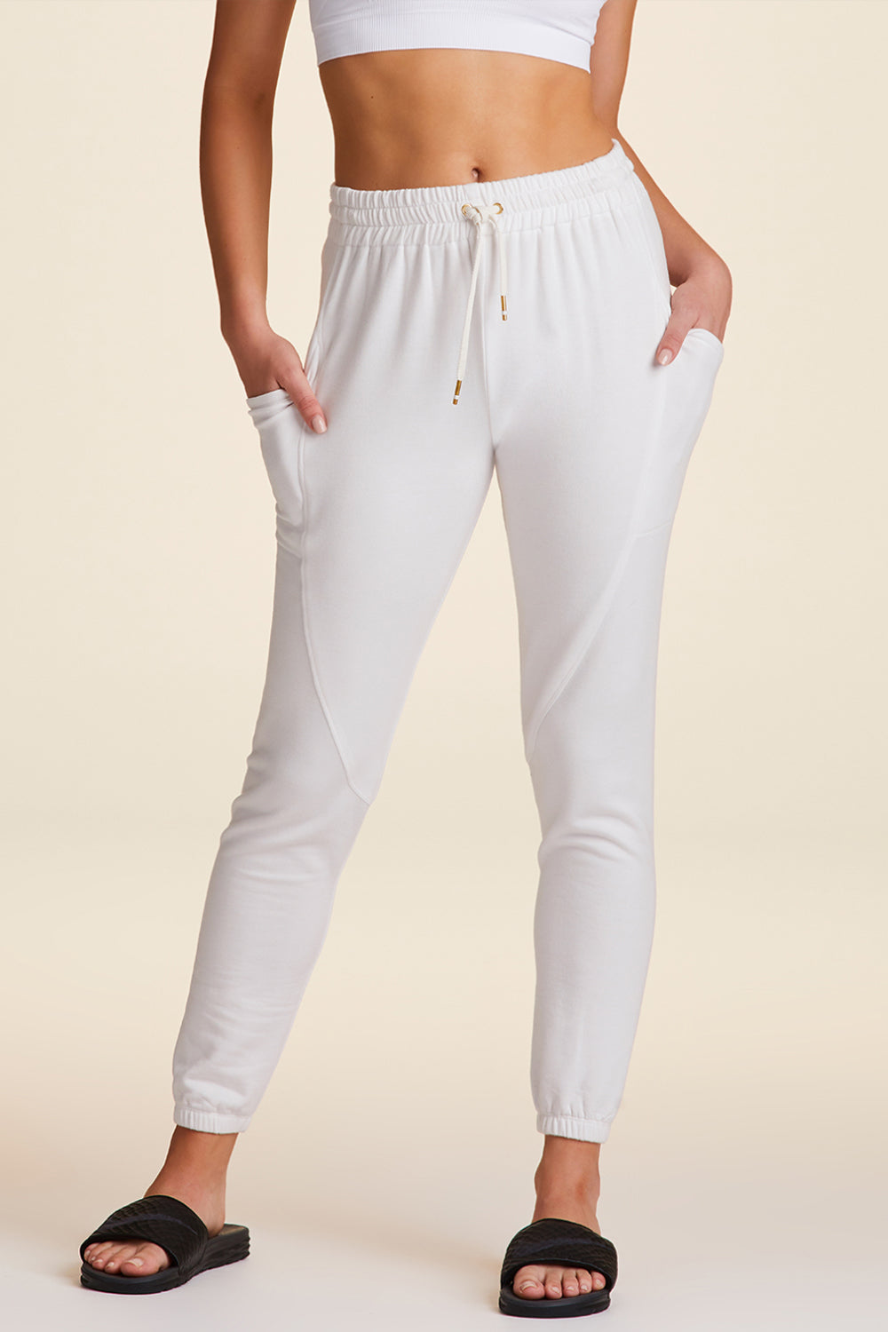 Front view of Alala Luxury Women's Athleisure super crewneck fleece sweatpant in white with pockets