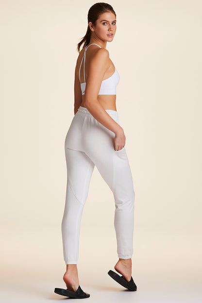 Full body back view of Alala Luxury Women's Athleisure super crewneck fleece sweatpant in white with pockets