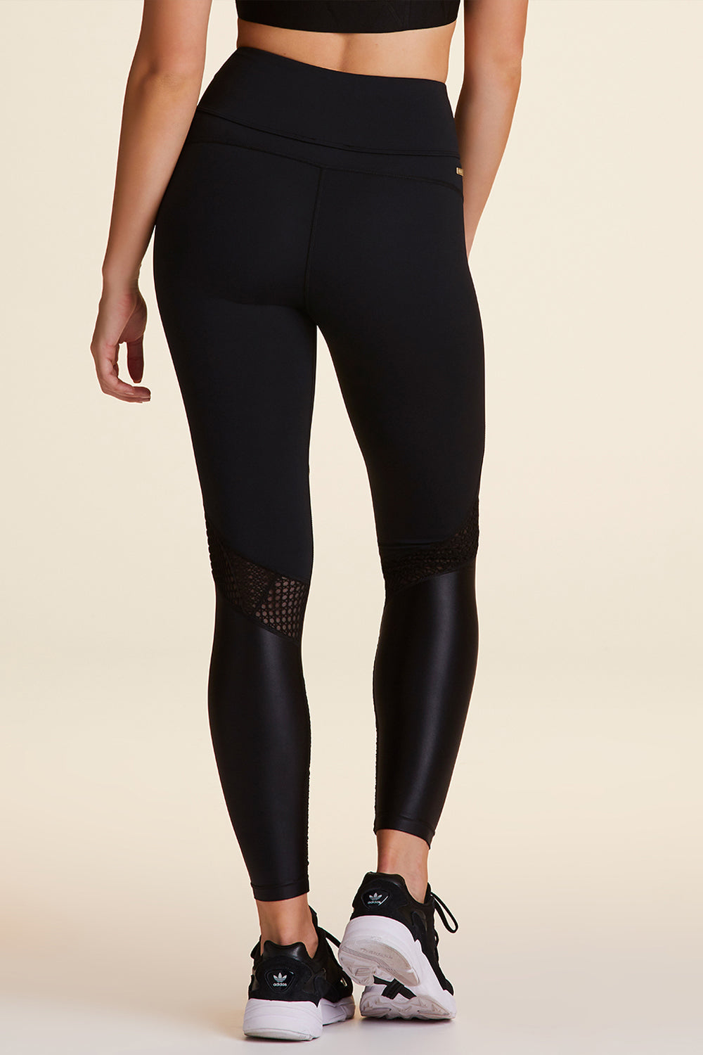 Back view of Alala Luxury Women's Athleisure collage tight in black