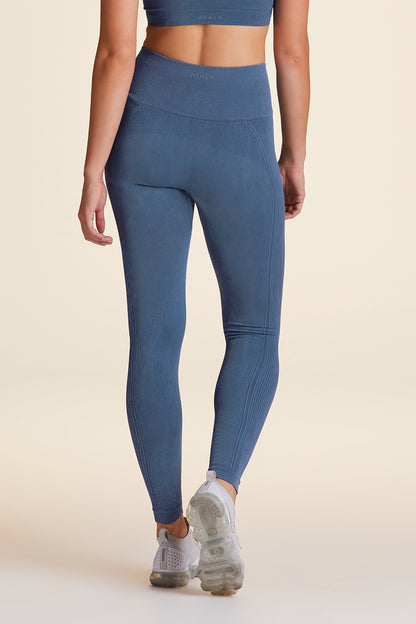 Back view of Alala Women's Luxury Athleisure flow seamless tight in blue with rib detailing