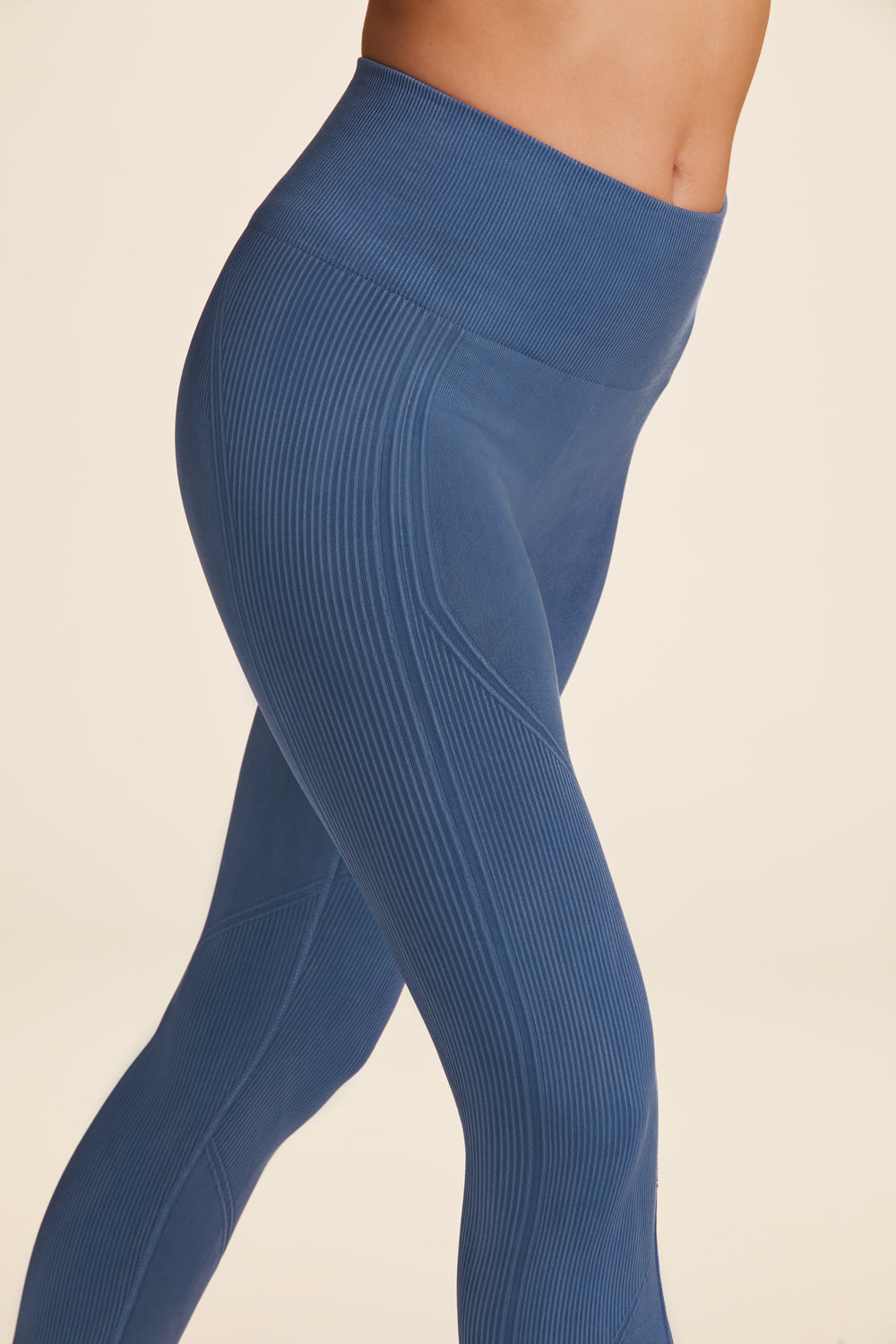 Zoomed in side view of Alala Women's Luxury Athleisure flow seamless tight in blue with rib detailing