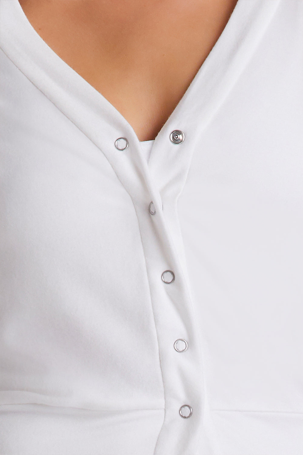 Zoomed in view of snaps on Alala Luxury Women's Athleisure snap cardigan in bone
