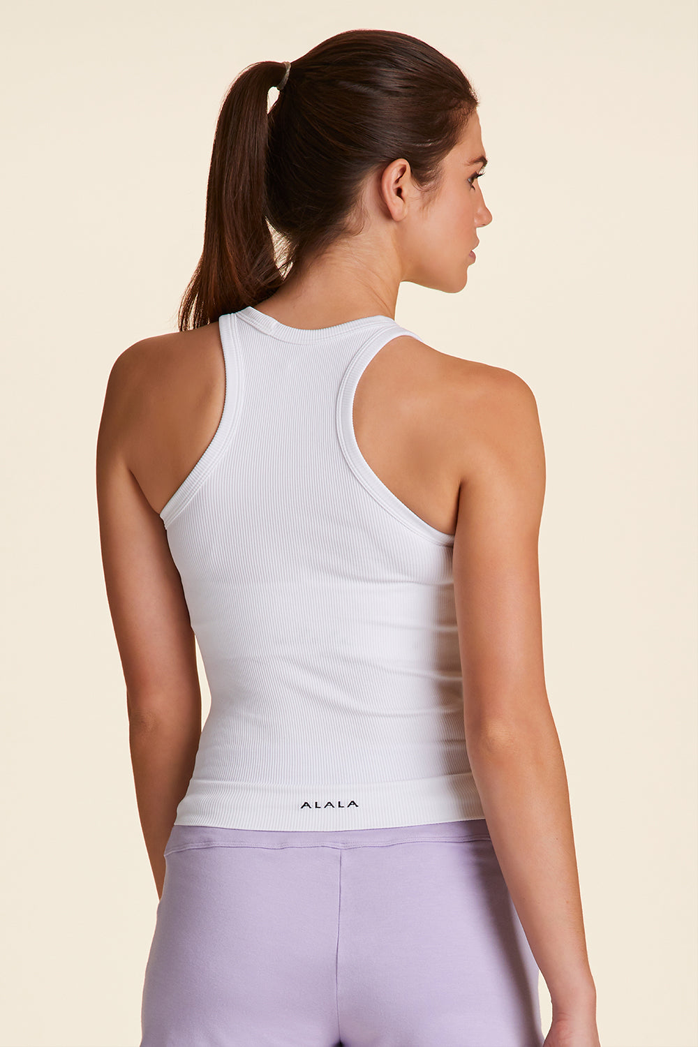Back view of Alala Women's Luxury Athleisure seamless rib tank in white