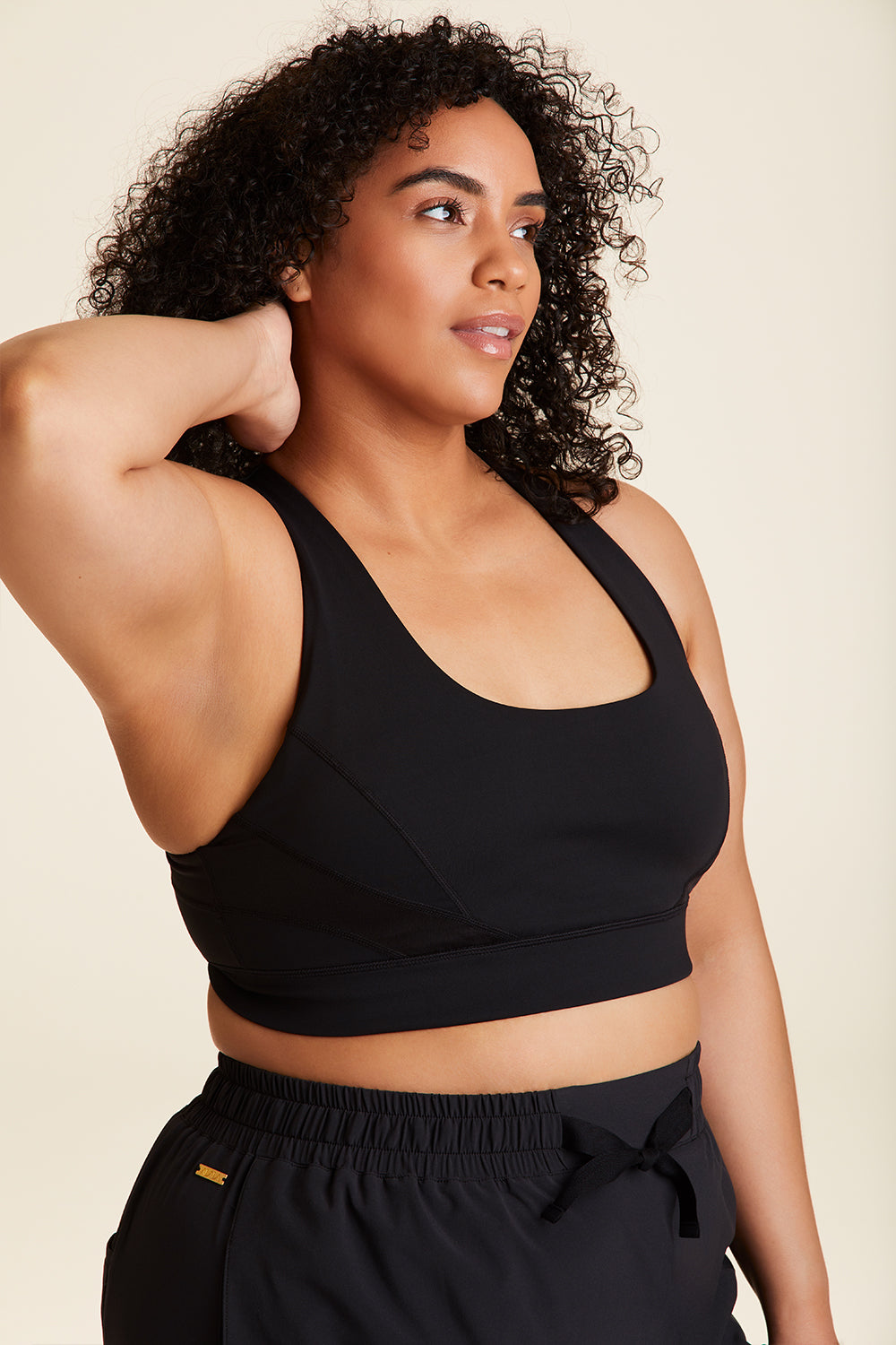 Side view of Alala Luxury Women's Athleisure vamp bra in black with racerback fit