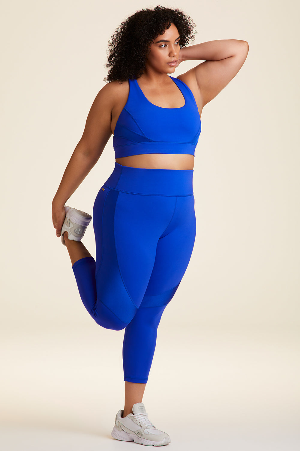 Side full body view of Alala Luxury Women's Athleisure vamp bra in cobalt blue with racerback fit in plus size
