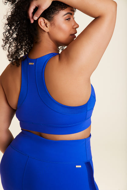 Back view of Alala Luxury Women's Athleisure vamp bra in cobalt blue with racerback fit in plus size
