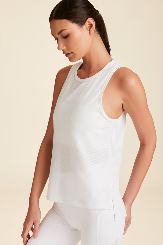 Front view of upper torso of model leaning to side wearing white Mirage Tank