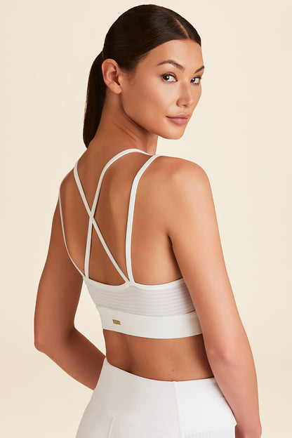 Back view of model posing in white Mirage Cami Bra showing back details