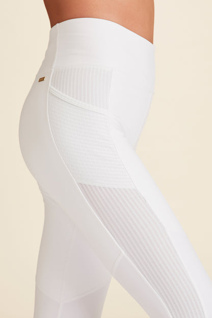 Closeup side view of white Mirage Tight showing pocket and breathable fabric details