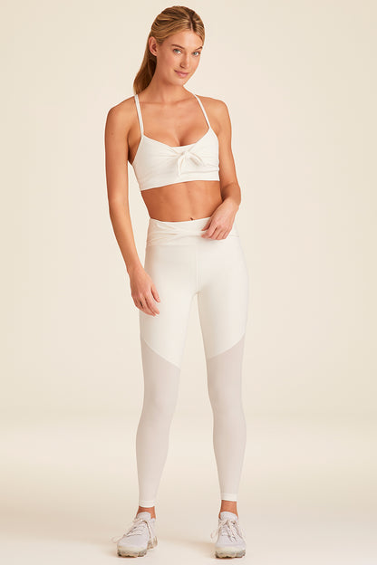 Full body front view of Alala Luxury Women's Athleisure tied bow tight in bone