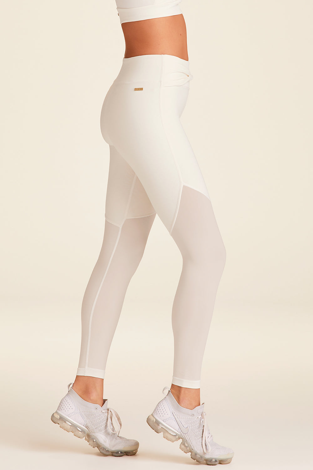 Side view of Alala Luxury Women's Athleisure tied bow tight in bone