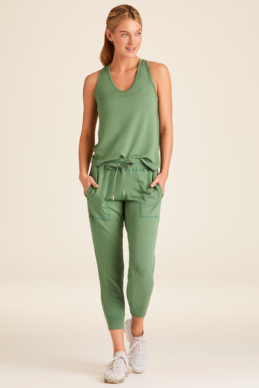Full body front view of Alala Luxury Women's Athleisure heron jogger in agave green