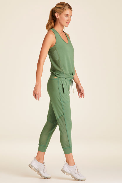 Full body side view of Alala Luxury Women's Athleisure heron jogger in agave green