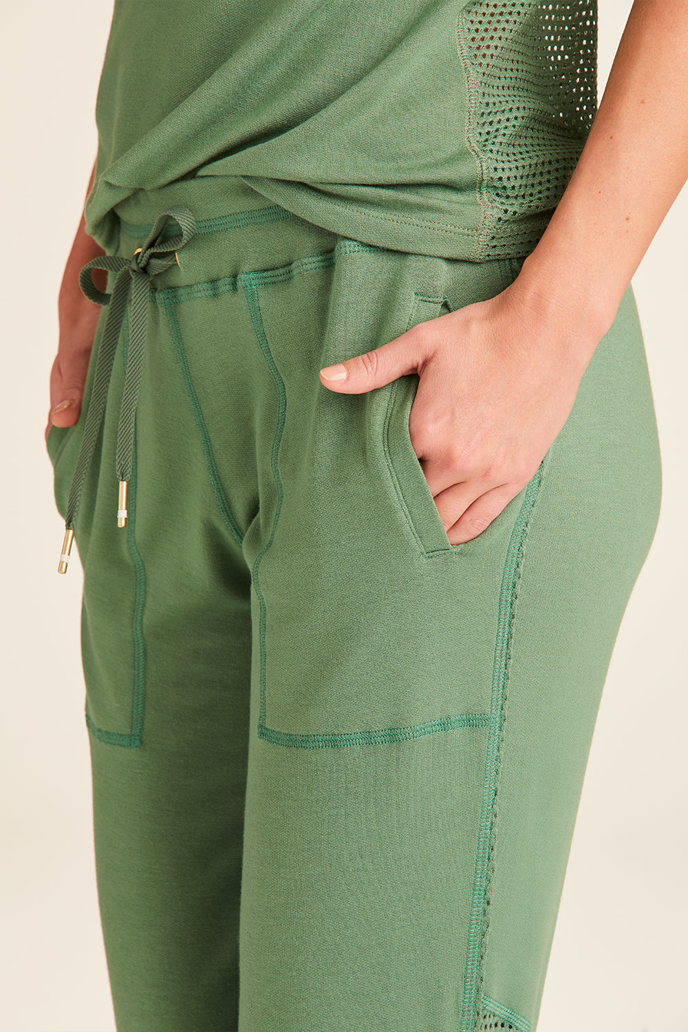 Zoomed in view of Alala Luxury Women's Athleisure heron jogger in agave green