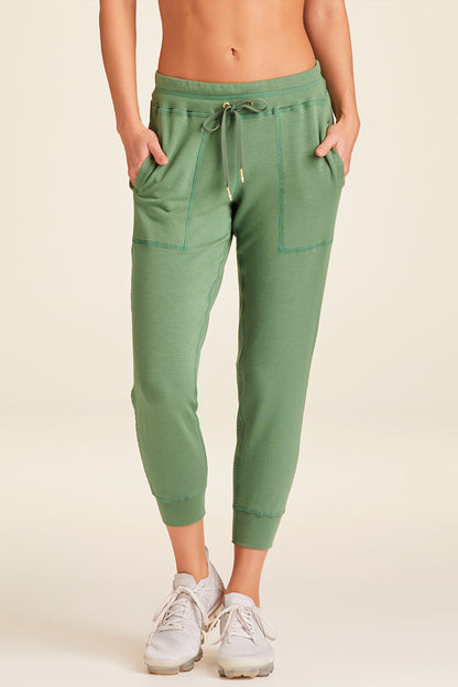 Front view of Alala Luxury Women's Athleisure heron jogger in agave green