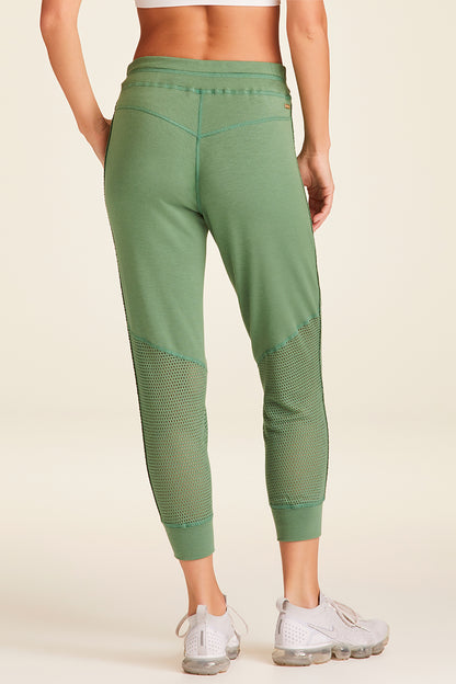 Back view of Alala Luxury Women's Athleisure heron jogger in agave green