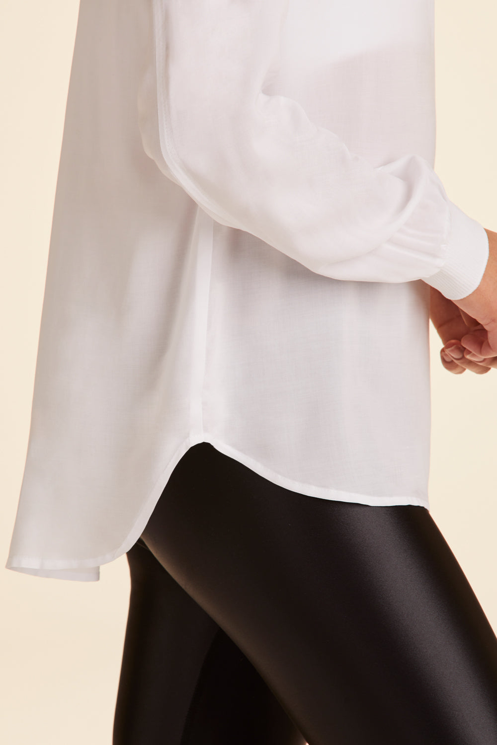 Zoomed in view of side of Alala Women's Luxury Athleisure lightweight woven pullover shirt in white