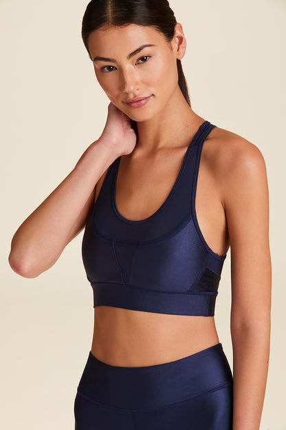 Front view of Alala Women's Luxury Athleisure navy sports bra with surf-inspired stiching