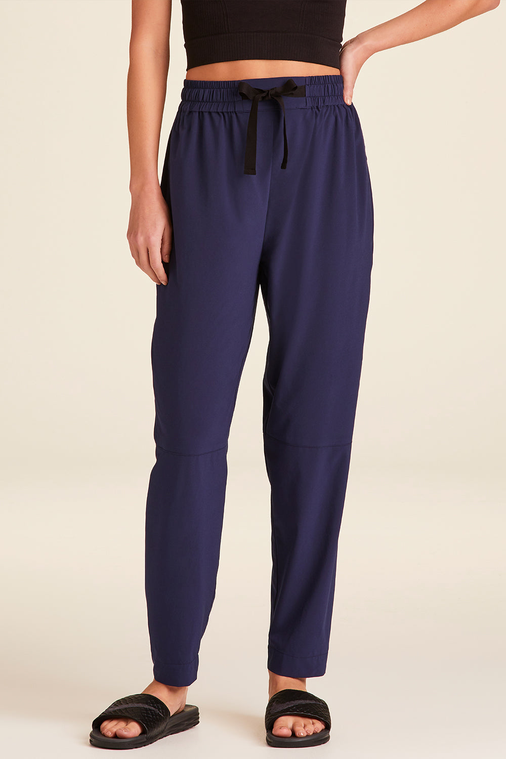 Front view of Alala Luxury Women's Athleisure commuter pant in navy