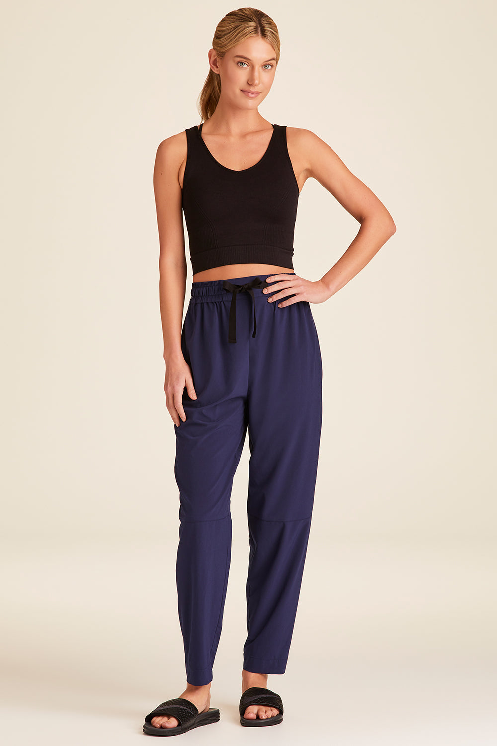 Full body front view of Alala Luxury Women's Athleisure commuter pant in navy