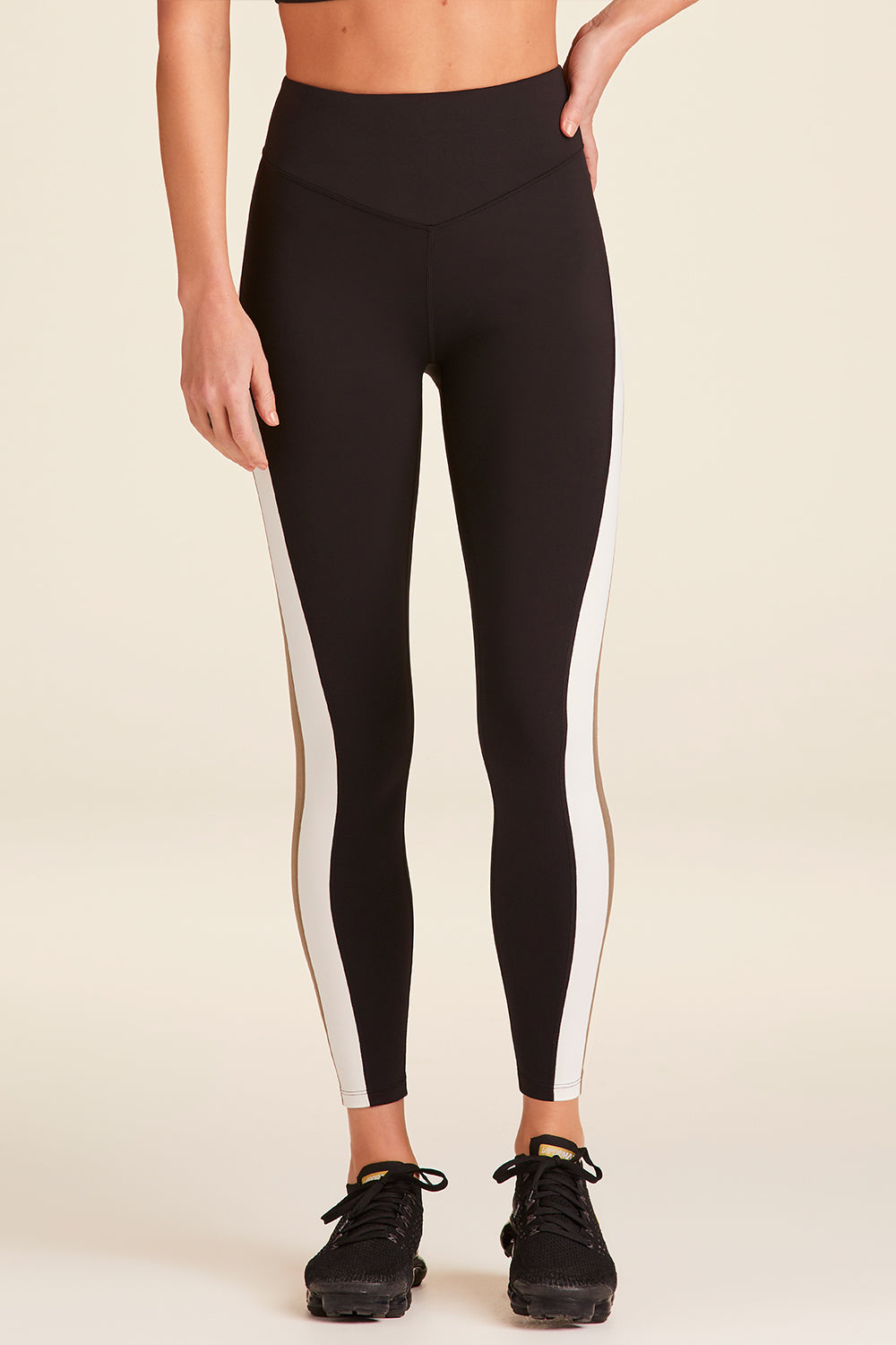 Front view of Alala Luxury Women's Athleisure bolt tight in black, gold, and bone