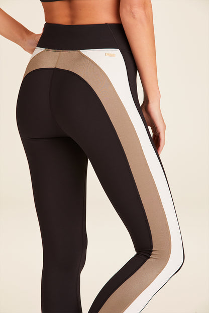 Zoomed in back view of Alala Luxury Women's Athleisure bolt tight in black, gold, and bone