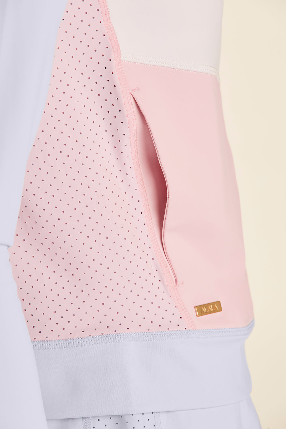 Closeup view of pink pocket of Alala Ace Jacket