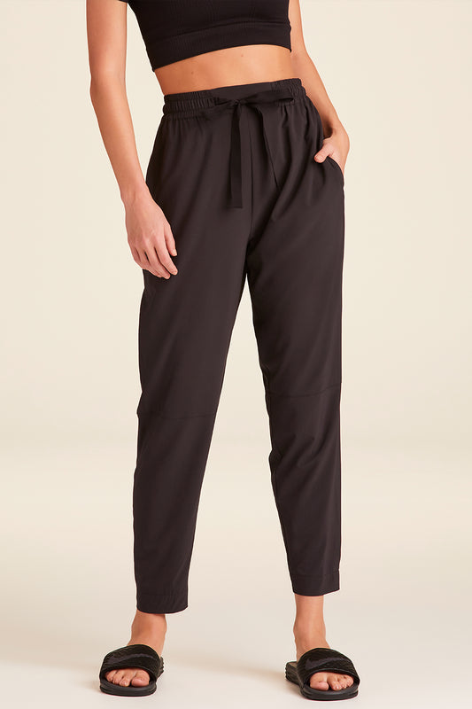 Front view of Alala Luxury Women's Athleisure commuter pant in black