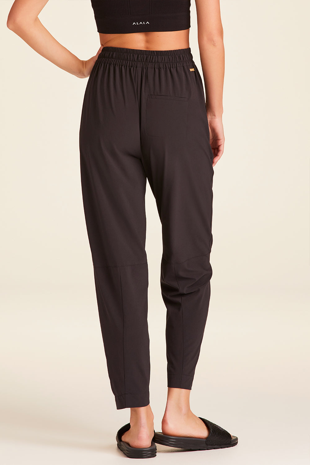 Back view of Alala Luxury Women's Athleisure commuter pant in black
