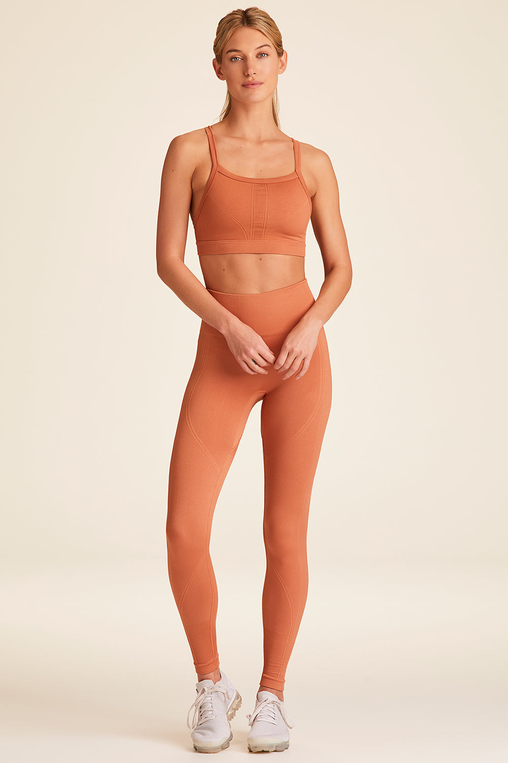 Front full body view of Alala Luxury Women's Athleisure flow seamless tight in terracotta