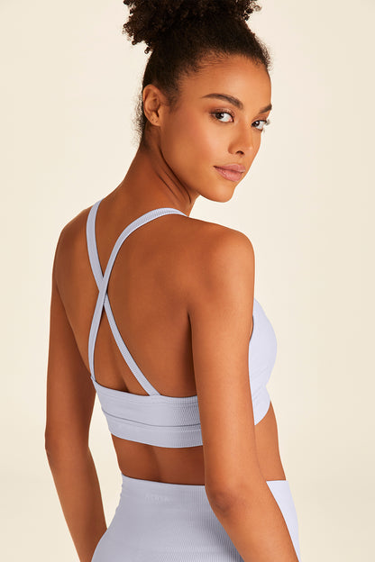 Back view of Alala Barre Cami Bra in blue with cross detailing visible