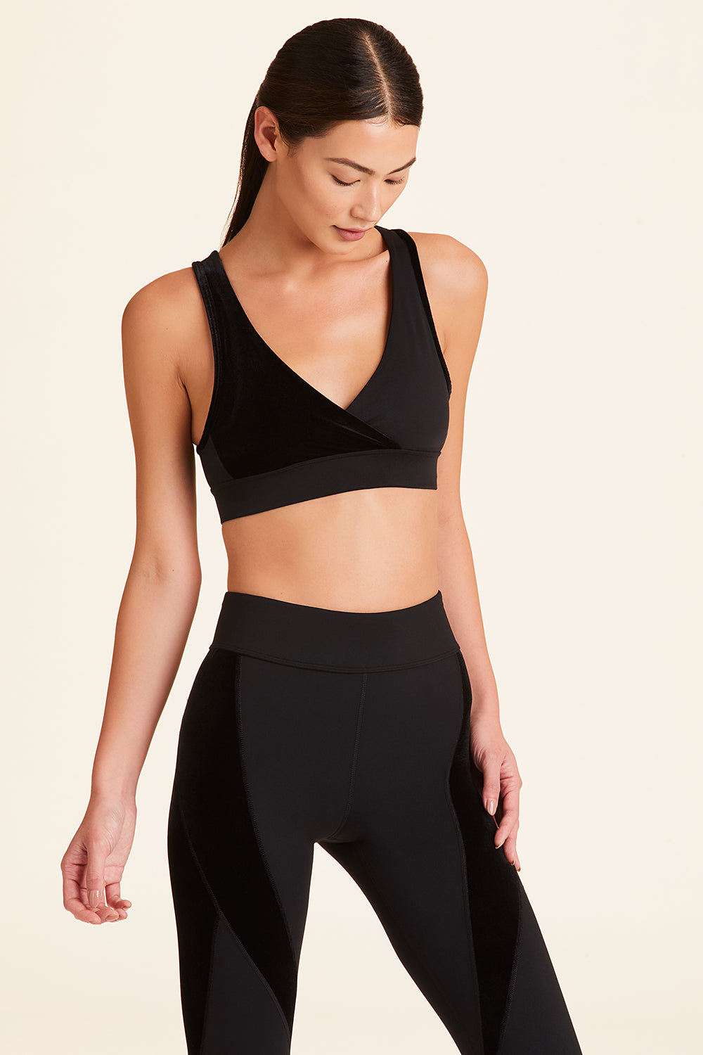 Front view of Alala Women's Luxury Athleisure athena bra in black with stretch velvet details