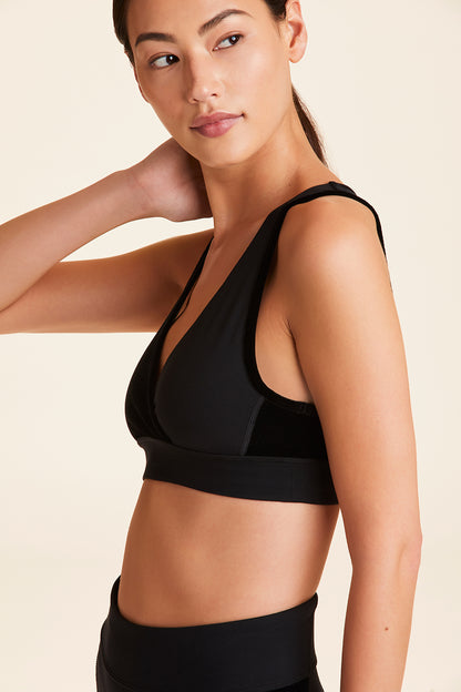 Side view of Alala Women's Luxury Athleisure athena bra in black with stretch velvet details