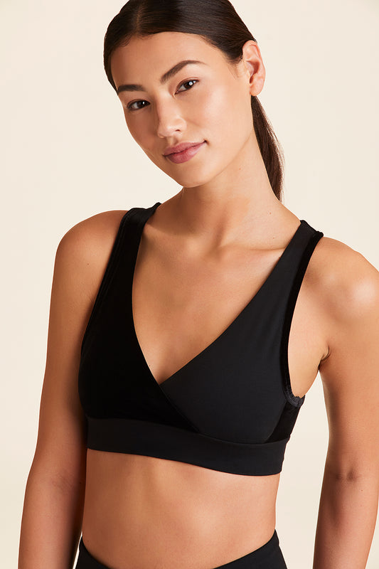 Front view of Alala Women's Luxury Athleisure athena bra in black with stretch velvet details