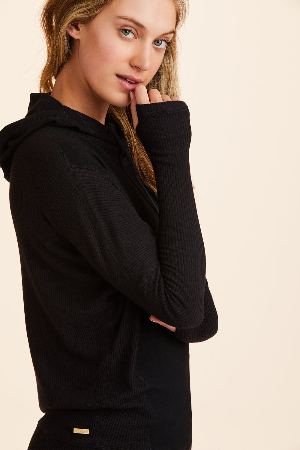 Side view of Alala Women's Luxury Athleisure black hoodie